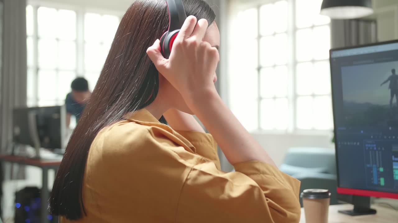 Asian Female Video Editor Start Works With Footage And Sound On Her Personal Computer In Office