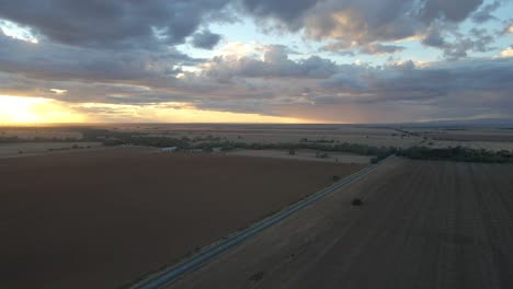 Australian-Countryside-road-crossing-agricultural-fields-Landscape,-Aerial-view