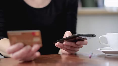 woman-paying-by-credit-card-for-online-shopping-using-smart-phone-in-hand-stock-video-stock-footage