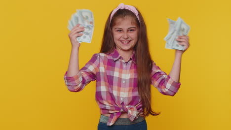 Successful-rich-child-girl-kid-holding-money-cash-dancing-listening-music-lottery-game-win-income