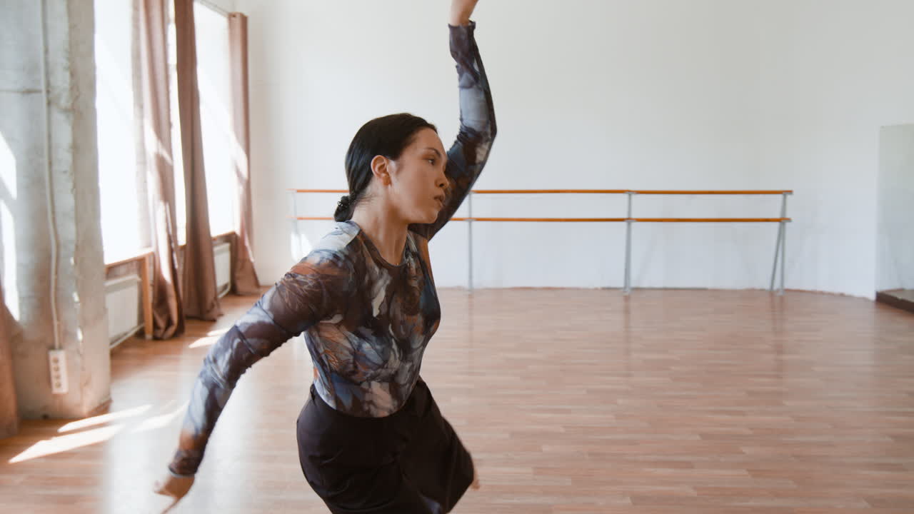 Woman practicing contemporary dance in a studio