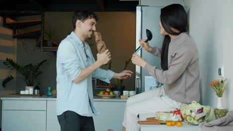 couple singing and having fun in kitchen