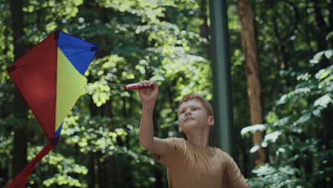 Ginger-boy-have-fun-with-kite-at-playground.