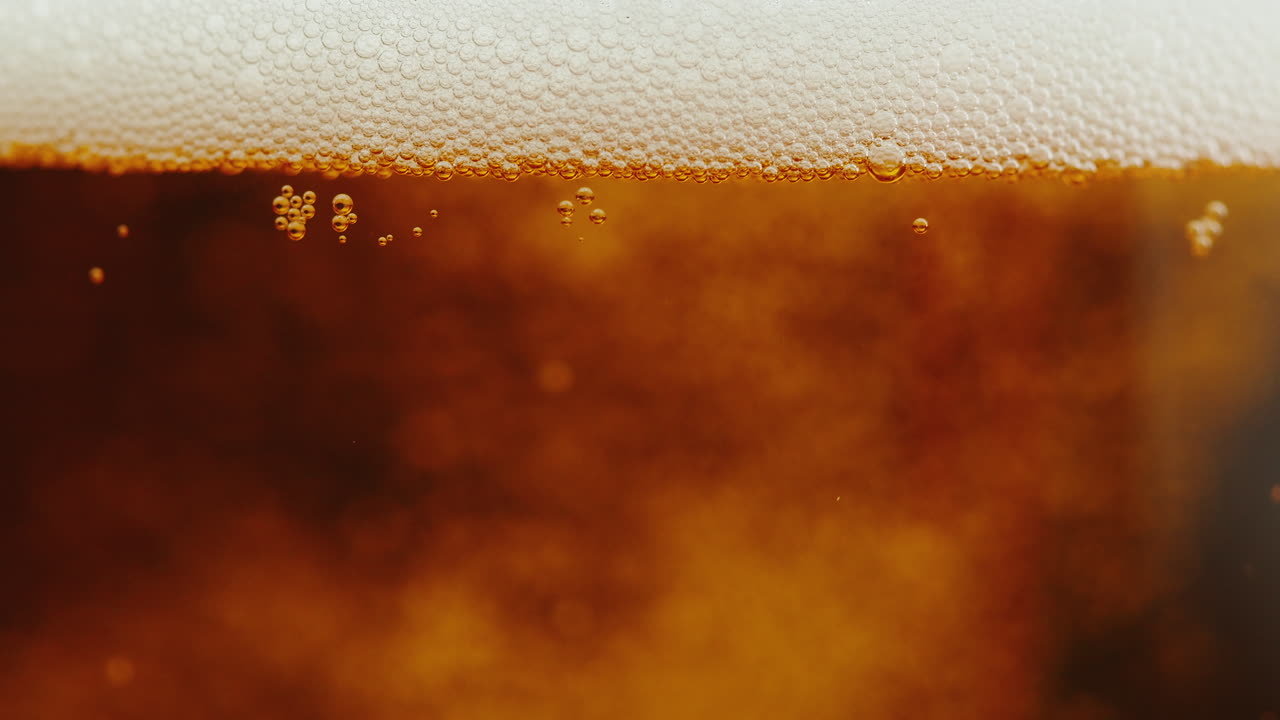 Close-up of beer foam and bubbles