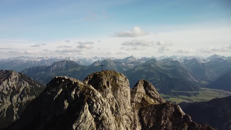 Drone-flying-away-from-a-summit-in-the-alps