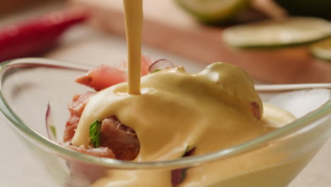 preparing tuna ceviche with creamy sauce
