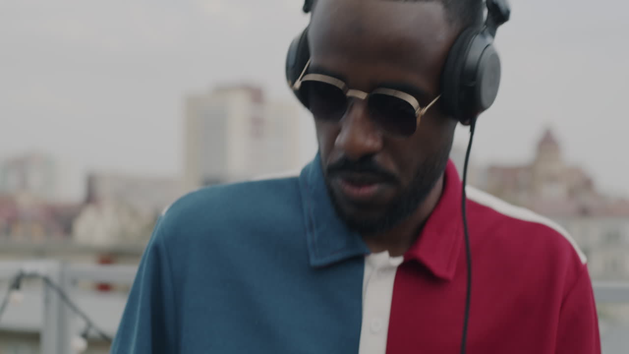 Man Enjoying Music on Rooftop