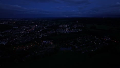 Darkness-of-night,-deep-blue-sky,-village-of-lights-below