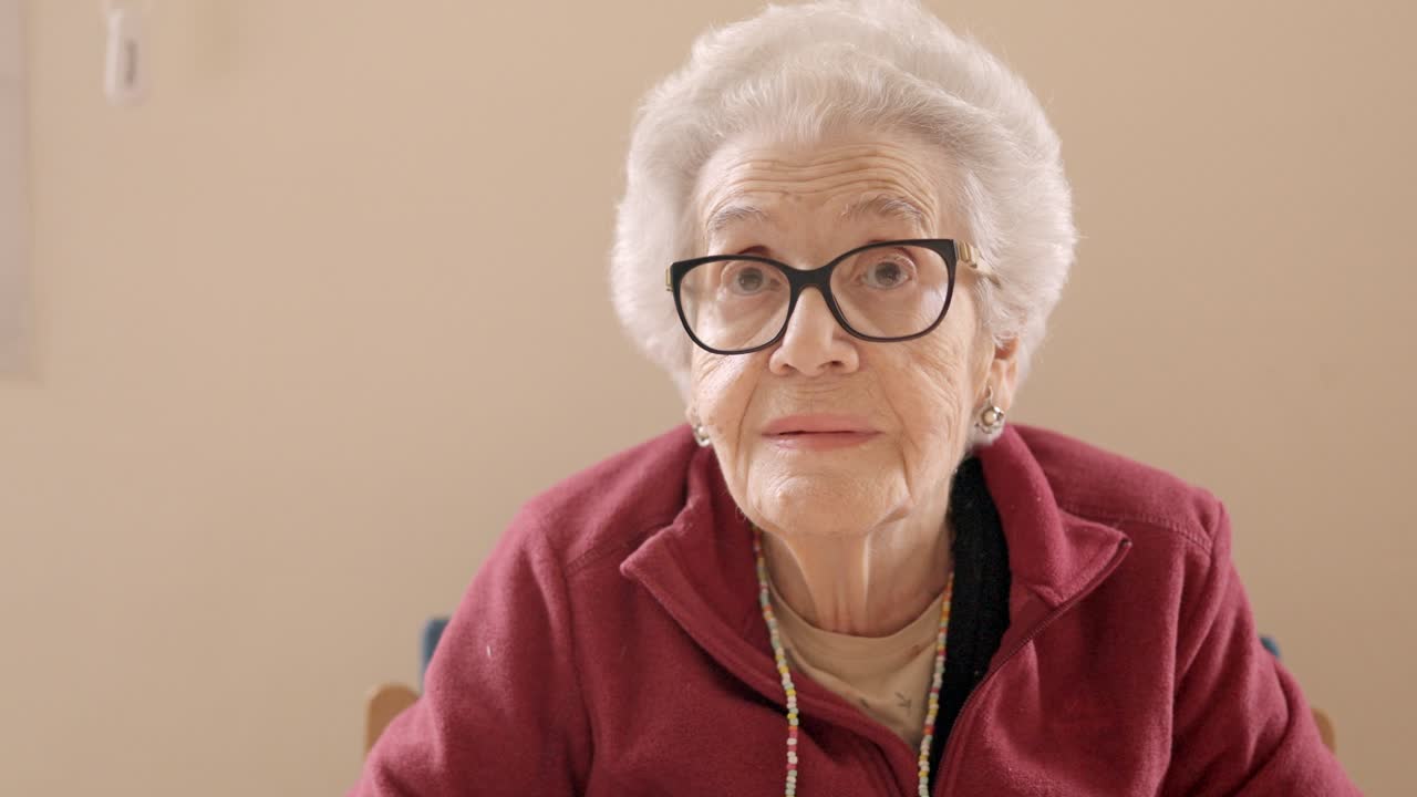 Senior woman with spectacles looking at camera in a geriatric