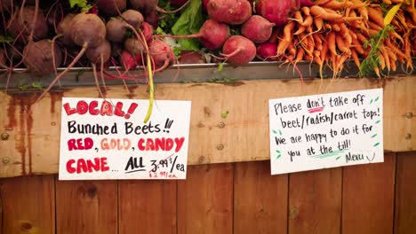 bunches of all natural probiotic antioxidant rich beets and carrots vegetables in a wooden crate local organic free range farmers market grocery store in winnipeg manitoba canada