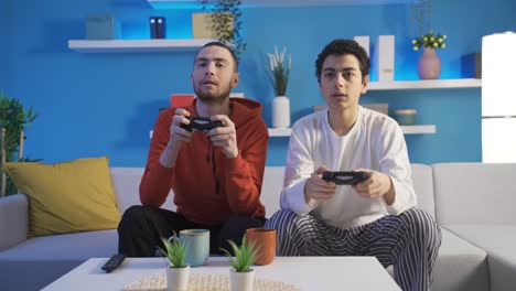 brother men playing video games together with game consoles.