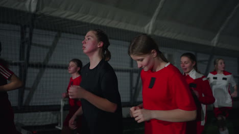 girls youth soccer team running and training