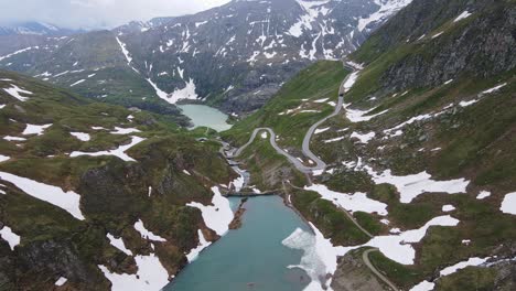 drone view of grossglockner high alpine road, winding near naßfeld speicher lake