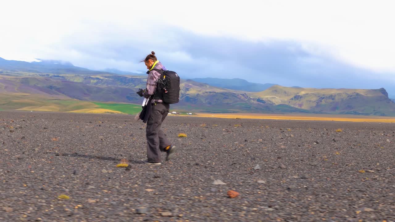 Icelandic explorer trekking vast black plain, iconic mountain backdrop