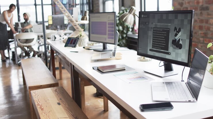 Modern office space designed for business, with multiple desks, computers, and casual atmosphere