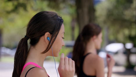 two fitness athletic friends jogging in the urban city