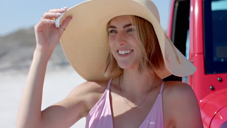 Young-Caucasian-woman-enjoys-a-sunny-beach-day-on-a-road-trip