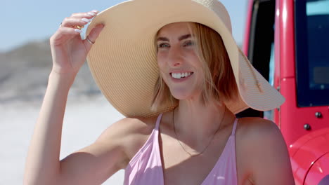 young caucasian woman enjoys a sunny beach day on a road trip