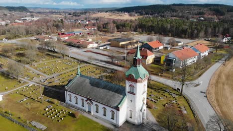 aerial drone flyover björketorp church and cemetery in rävlanda, sweden