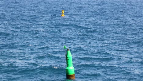 green buoy floating in the ocean