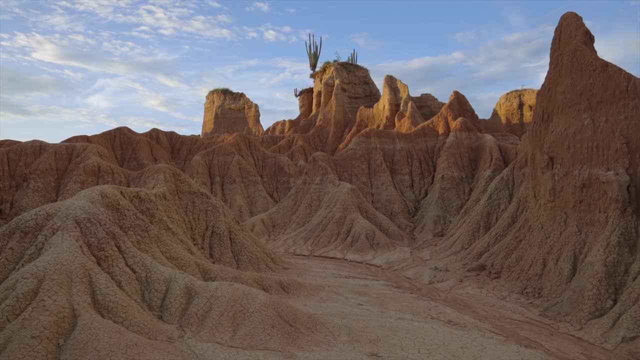 Establishing of Tatacoa Desert in Colombia, jagged red rock formations and a dramatic landscape accented by sunset light
