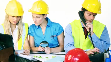 tres arquitectos atractivos trabajando en la oficina