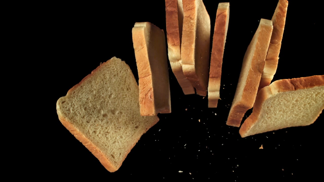 Slices of White Bread Falling and Levitating on Black Background