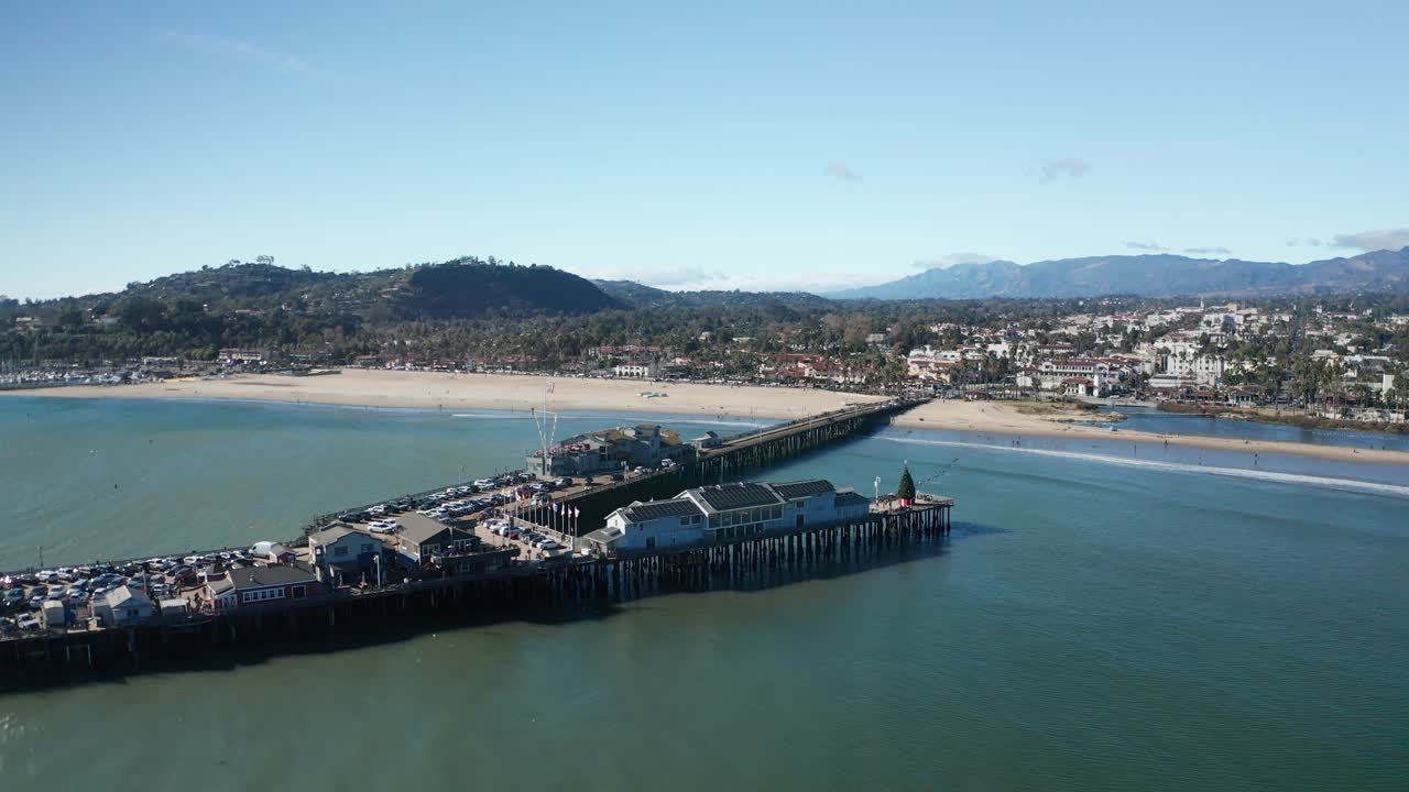 Aerial pullback panning shot of Stearns Wharf in Santa Barbara, California. 4K