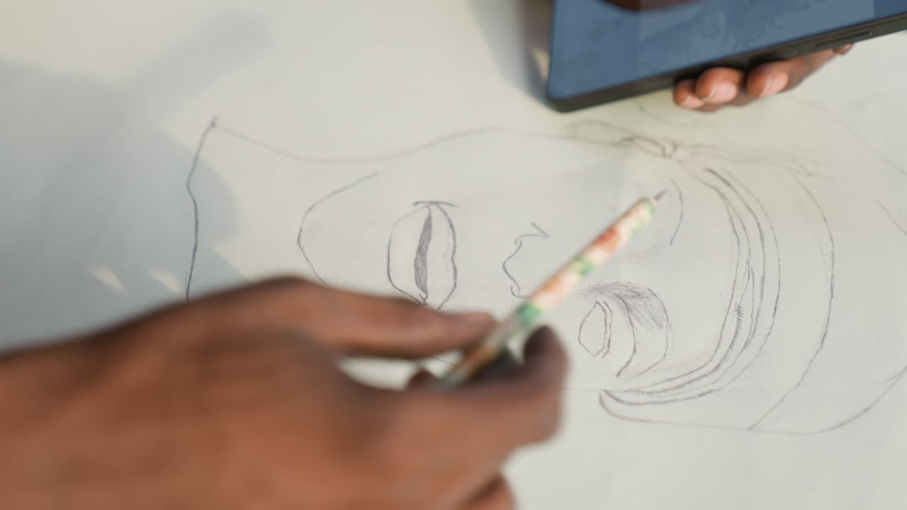 Artist refines portrait. Focused studio session capturing detailed facial features with precision. An artist attentively improves portrait using digital tools and careful shading techniques