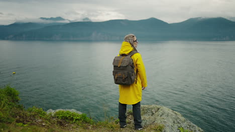 woman hiking by a lake in rainy weather