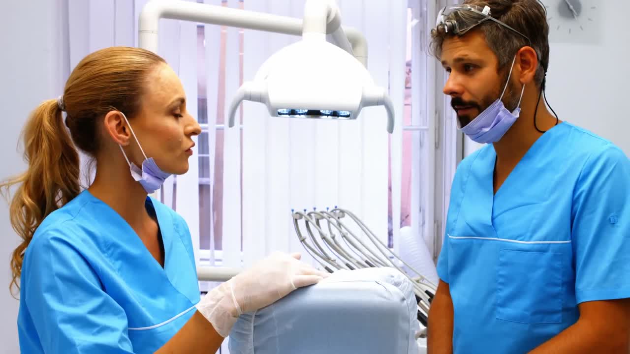 Dentists interacting with each other at dental clinic