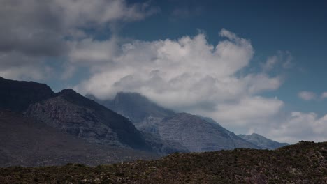 Time-Lapse-of-Majestic-Clouds-Floating-Over-Mountain-Range-4K