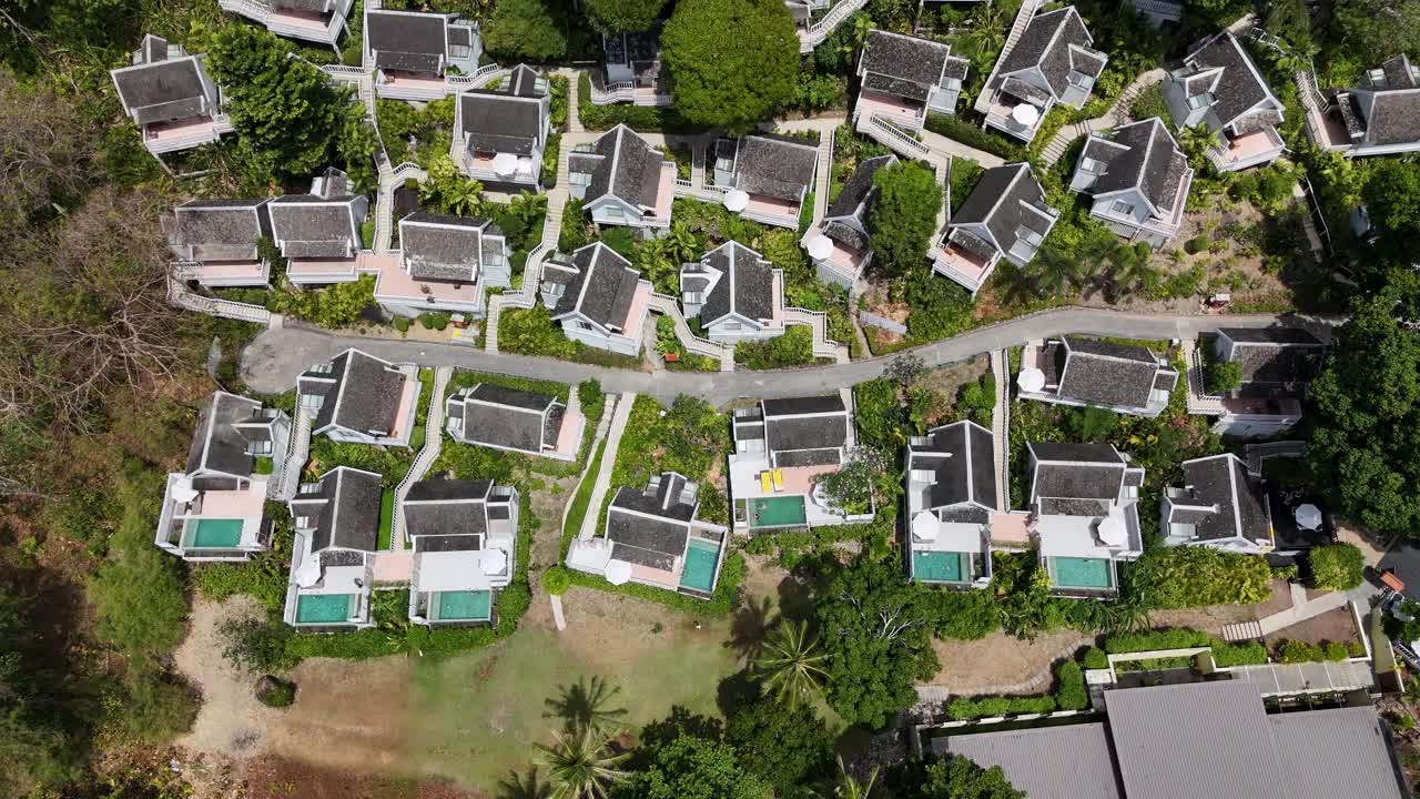 Drone footage showcasing luxury villas with pools in Phuket, Thailand. The video captures the lush greenery and modern architecture