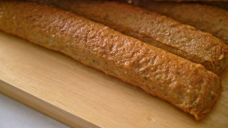 fried chinese fish cake or fish ball line on wood board