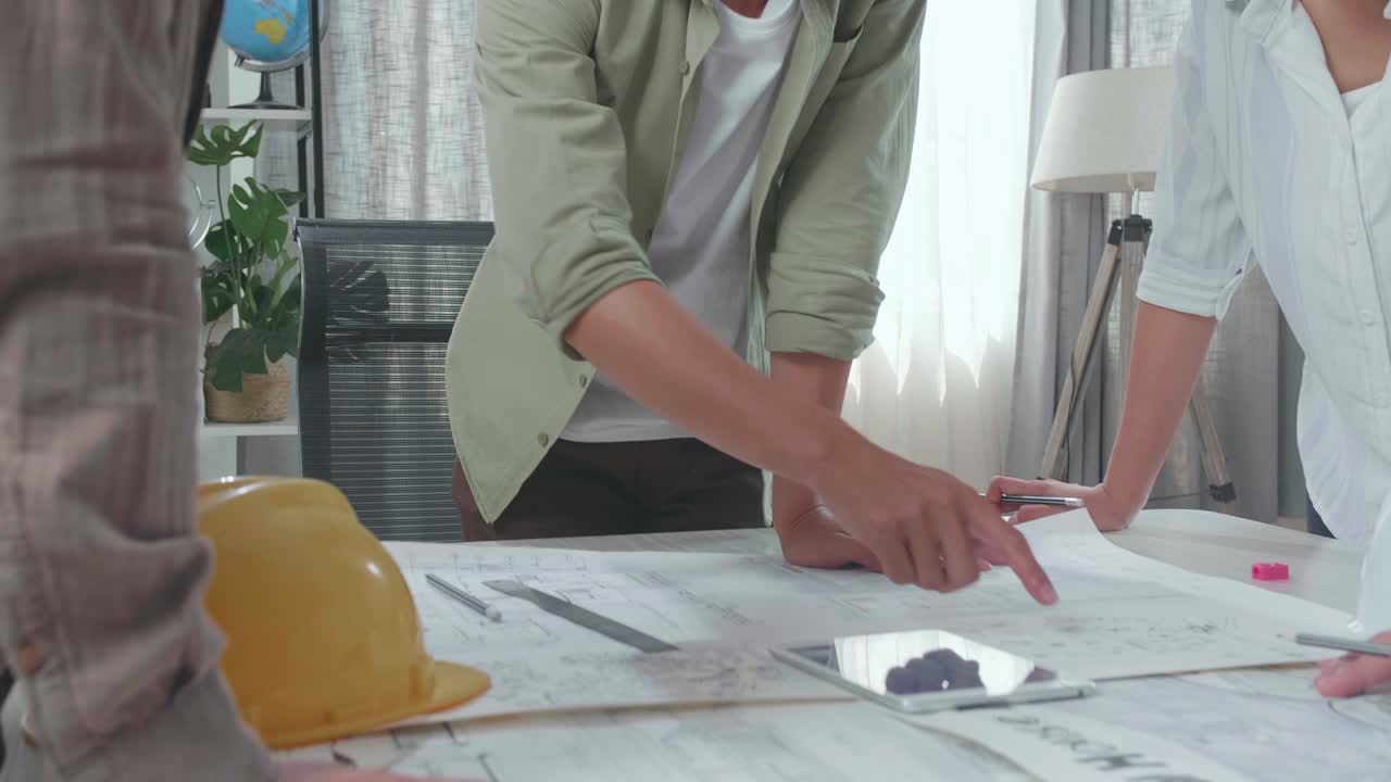 Group Of Asian Engineers Discuss About Work On The Tablet At The Office