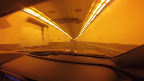 red car driving through a tunnel