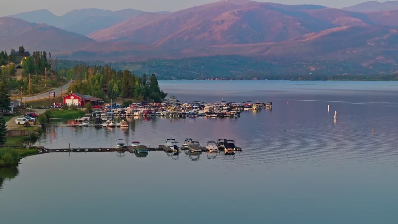Drone panoramic over Grand Lake Colorado harbor marina with boats at golden hour