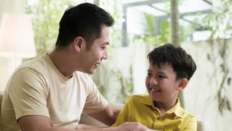 asian man and boy in the living room