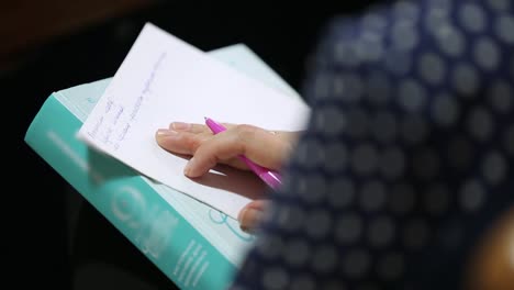 Female Hand Over Paper Notes. Female hand over paper making notes at seminar