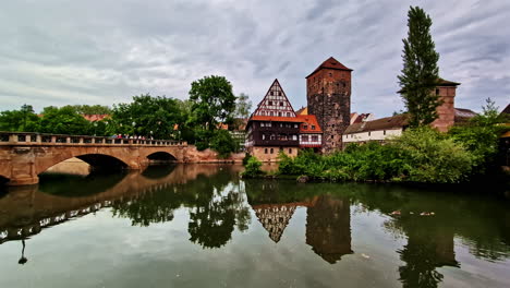 maxbrucke bridge and wasserturm tower reflecting in pegnitz river in nuremberg