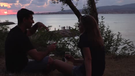 couple enjoying a romantic sunset by the sea