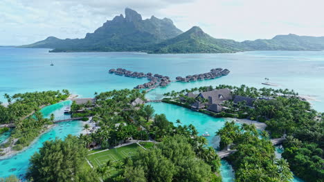 bora bora, french polynesia. drone shot of luxury resort with view on main island, overwater bungalows and lagoon