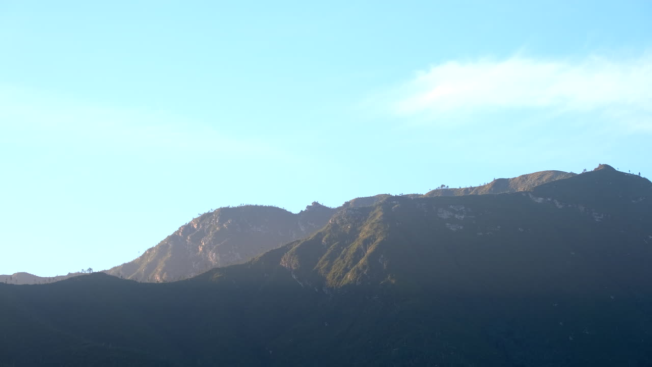 Outline of Outeniqua mountains silhouetted against blue sky lit up at sunrise