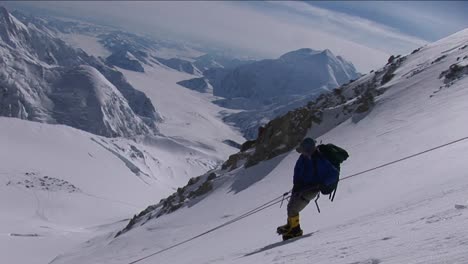 Climber-carefully-descending-steep-slope