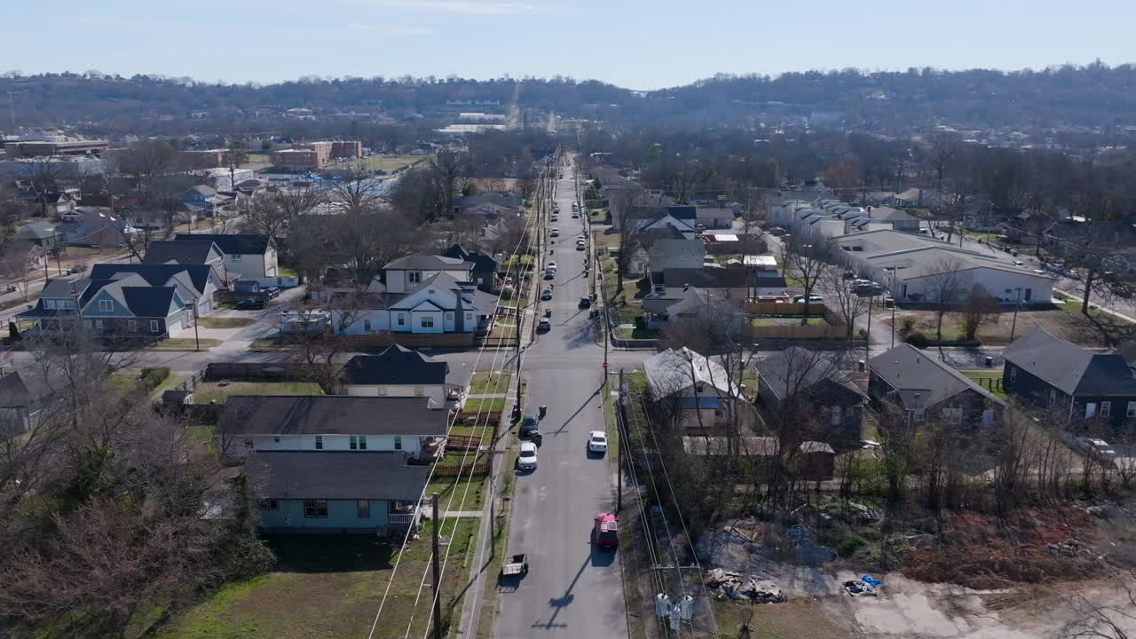 Aerial drone footage in the winter on a sunny day flying over a street in the Highland Park neighborhood of Chattanooga, Tennessee.