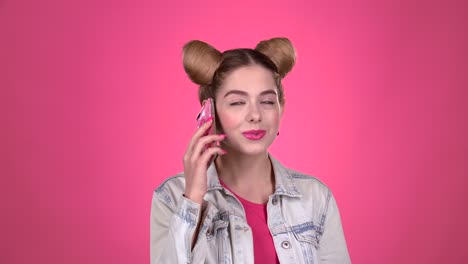 young woman on phone, pink background