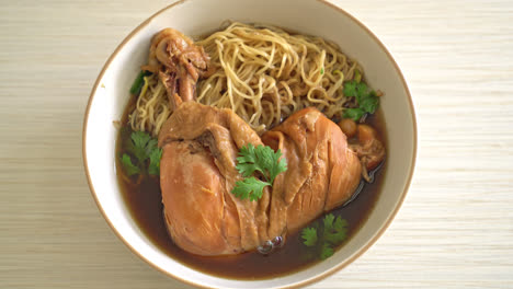 noodles with braised chicken in brown soup bowl - asian food style