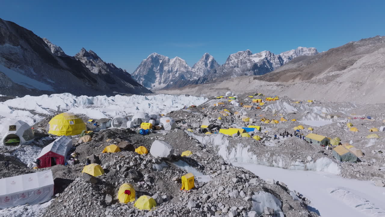 Drone view of Everest Base Camp with white Khumbu glaciers, climbers' tents where summit start point, and scenic Himalayan beauty for tourist climbers, dry lands, environmental protection Nepal