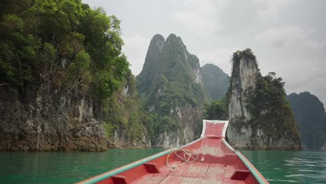 boat ride through scenic limestone karsts on a tropical lake in thailand