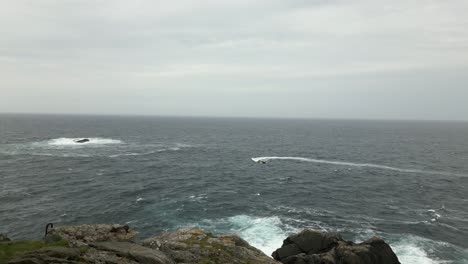 Rib-Boat-with-Tourists-next-to-Kråkenes-Lighthouse-with-Rough-Sea